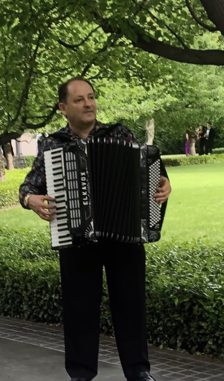 Giancarlo Ursino playing accordion at a gala event