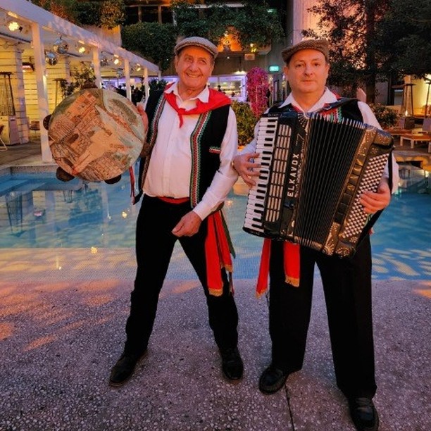 Giancarlo Ursino playing accordion alongside singer Peter Rizzo